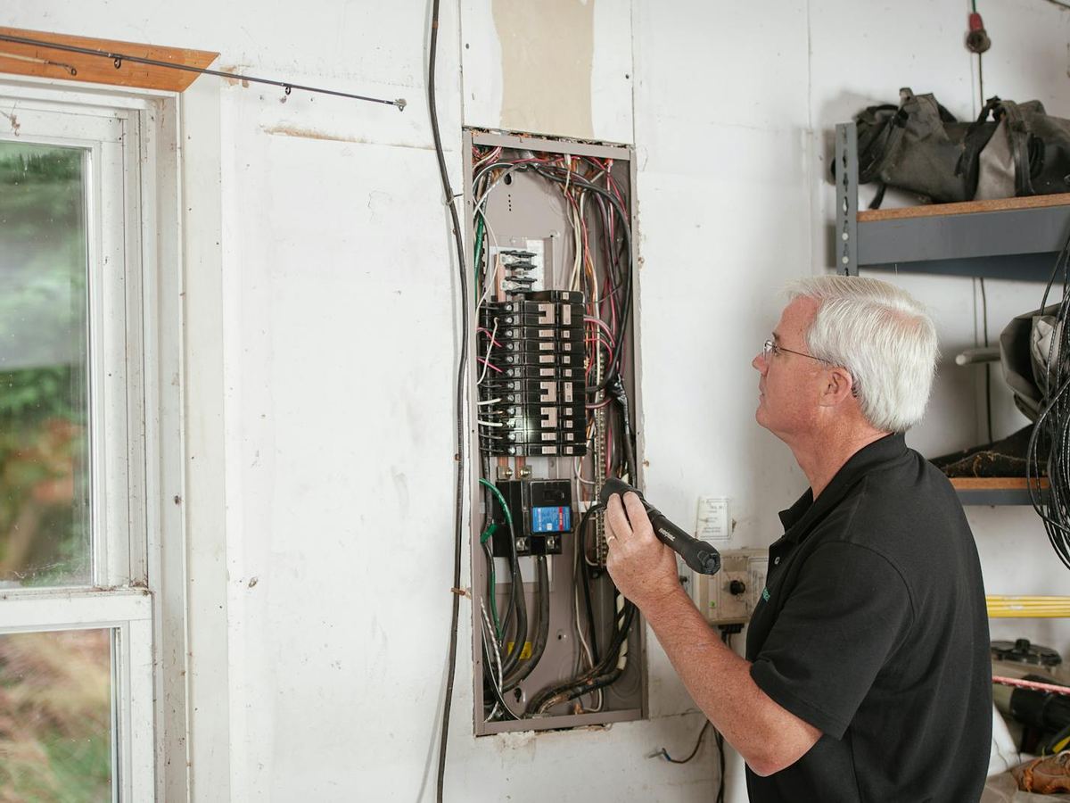 Qualified electrician working on a residential consumer unit