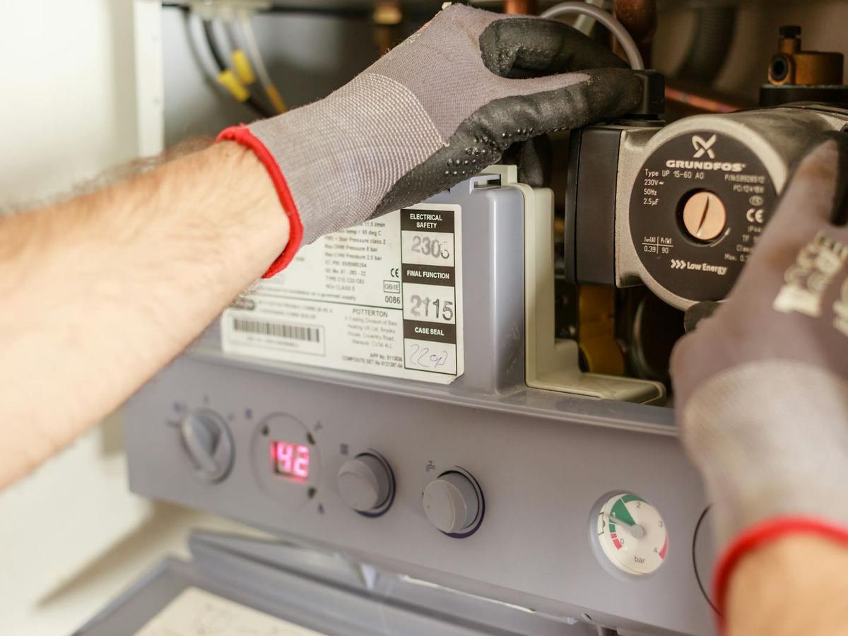 Heating engineer servicing a residential combi boiler