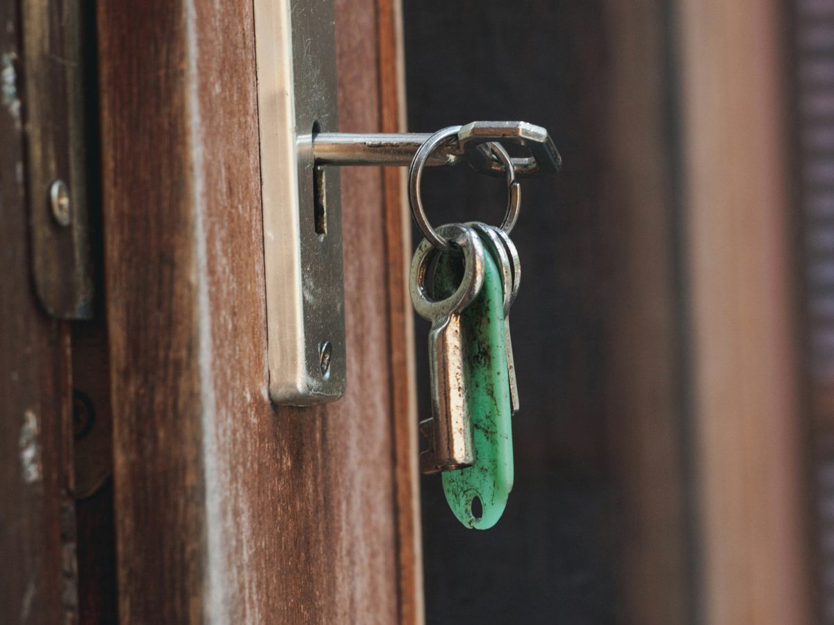 A set of keys in a front door lock, representing locksmith work in a local home setting